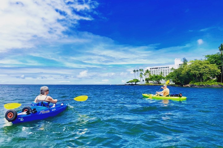 a group of people in a small boat in a body of water