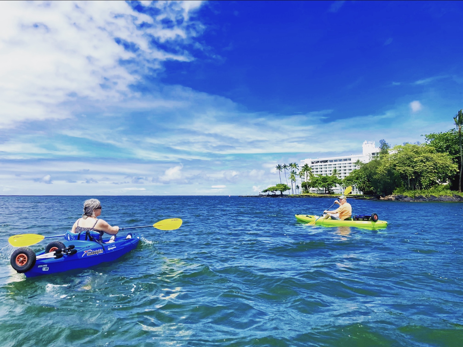 Kayakers paddling across Hilo Bay