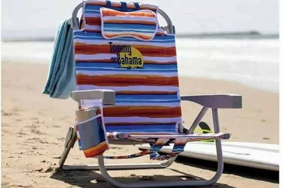 a chair sitting in the sand on a beach
