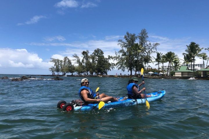 a group of people rowing a boat in the water