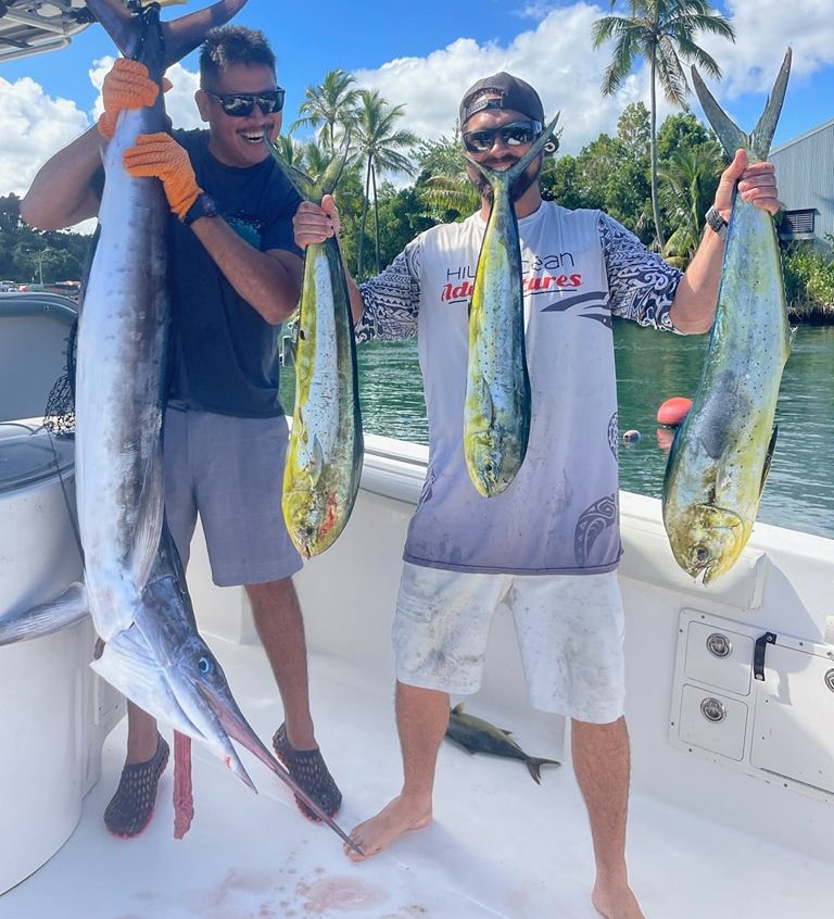 Two anglers on the boat holding a swordfish caught off Hilo