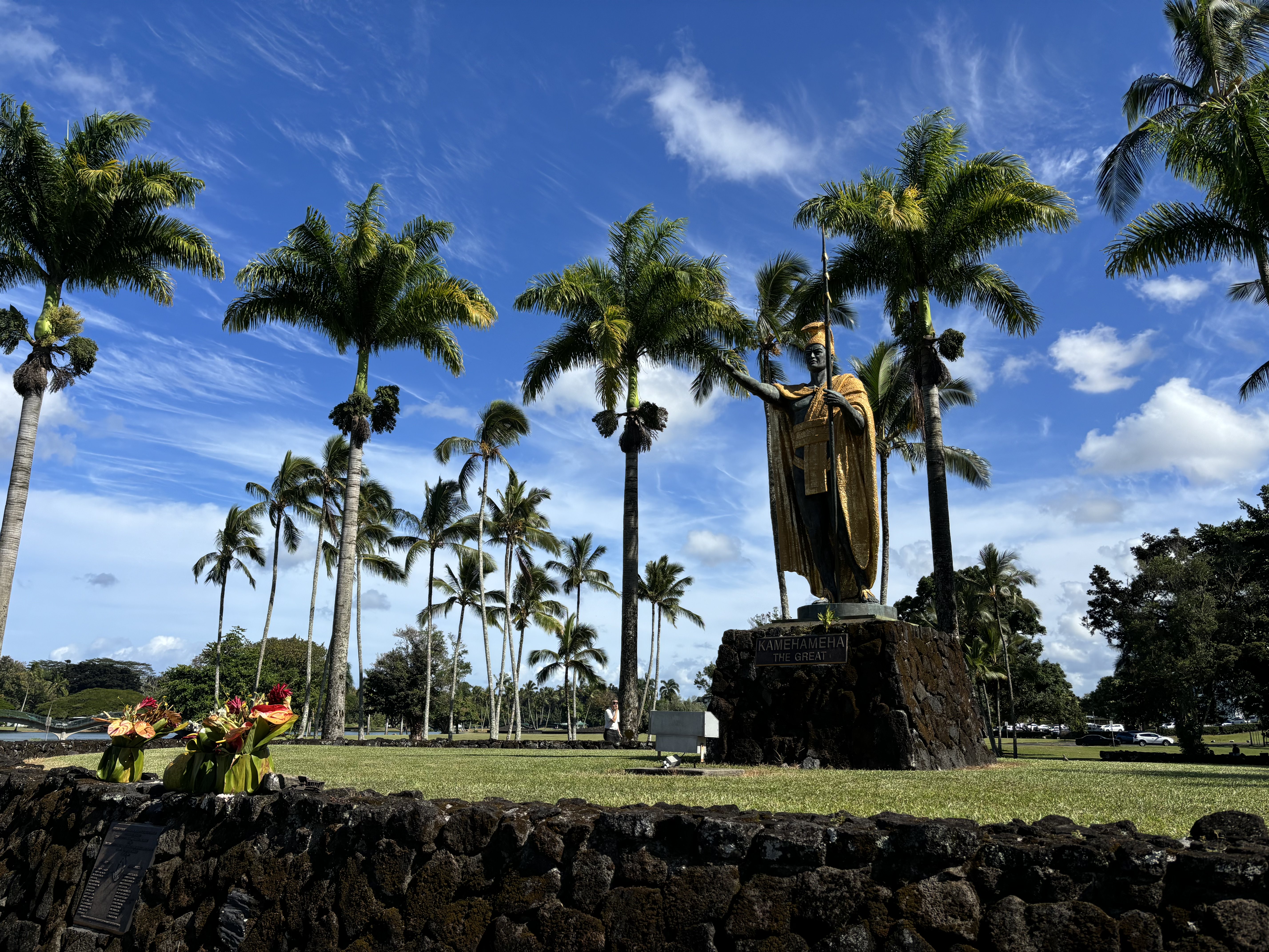 King Kamehameha statue surrounded by palm trees in Hilo