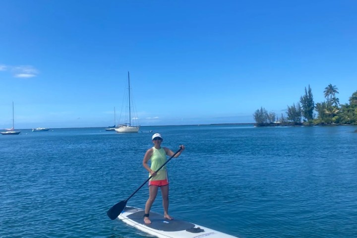 a man riding on the back of a boat in a body of water