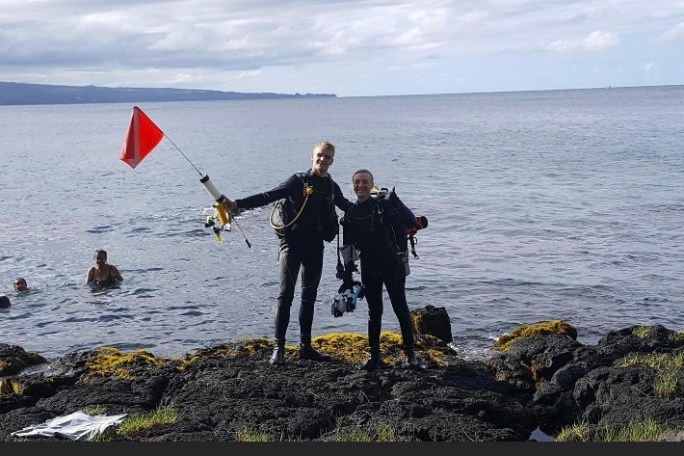a group of people on a beach near a body of water