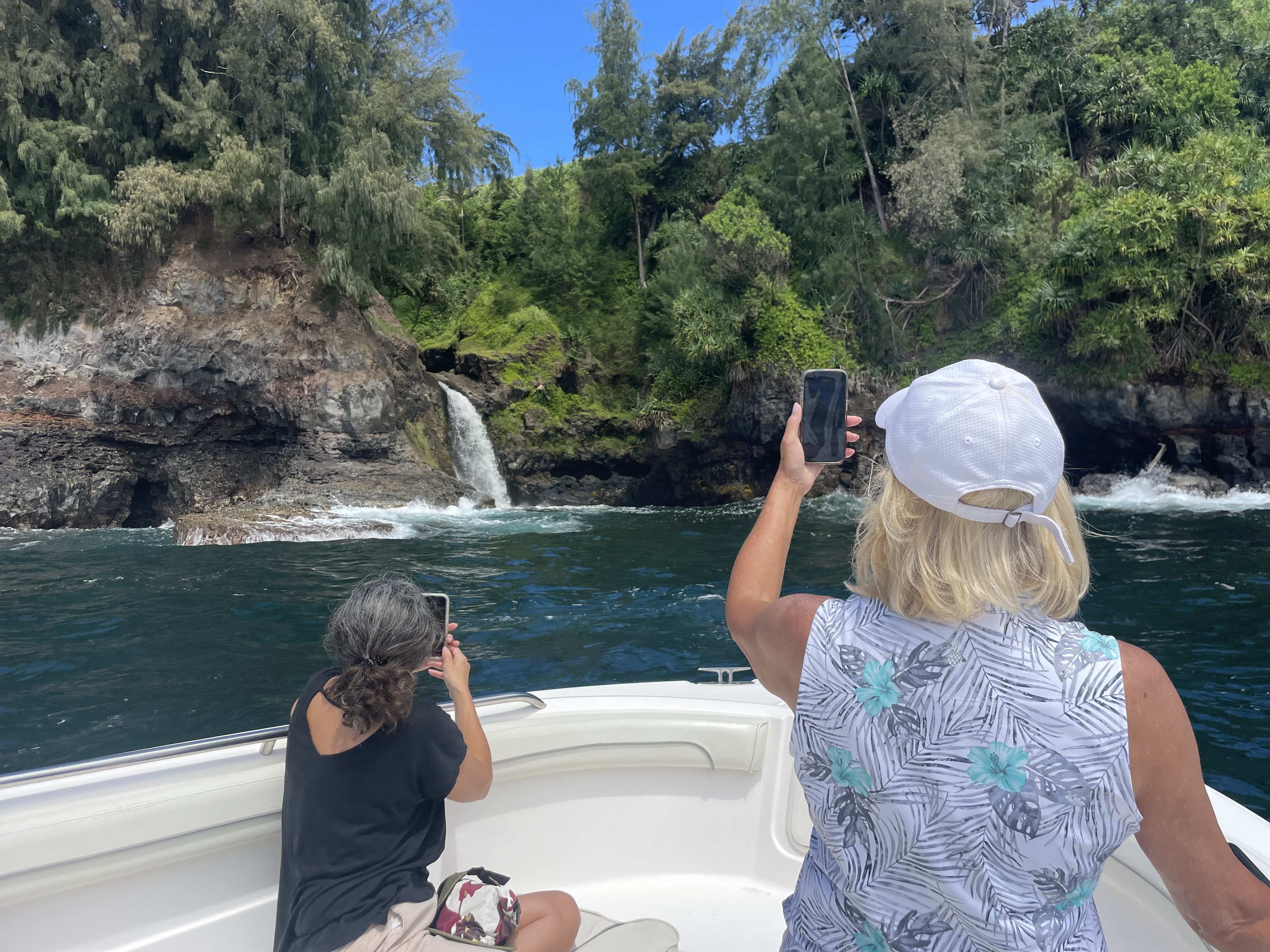 Waterfall pouring off sea cliffs on the Hāmākua Coast