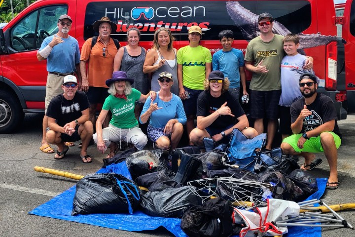 Soamsawali et al. sitting around a car