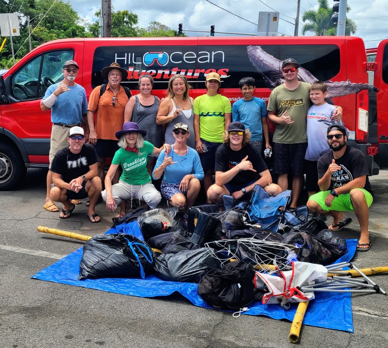 Soamsawali et al. sitting around a car