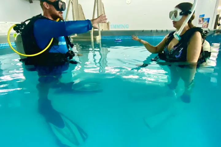 a couple of people that are standing in the water