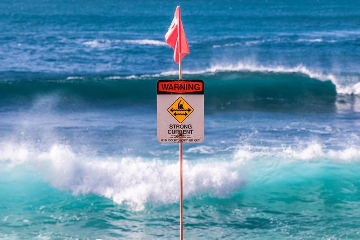 a person riding a wave on a surfboard in the ocean