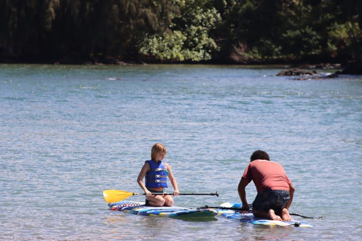 a group of people rowing a boat in a body of water