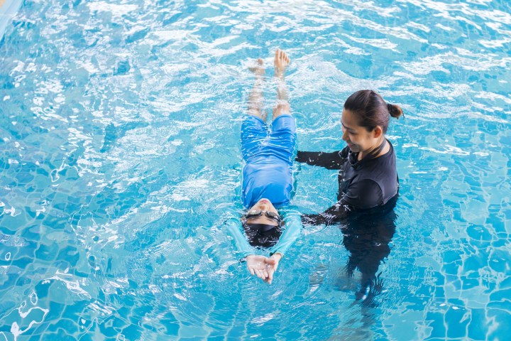 a man swimming in a pool of water