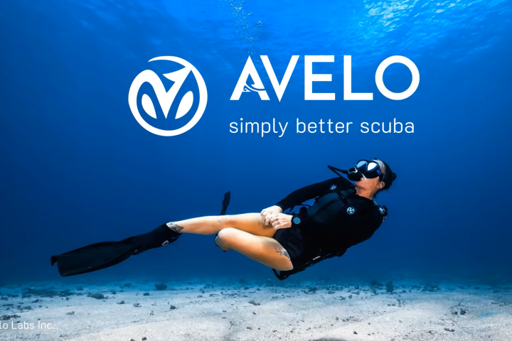 Diver underwater next to 'AVELO simply better scuba' logo on a blue ocean background.
