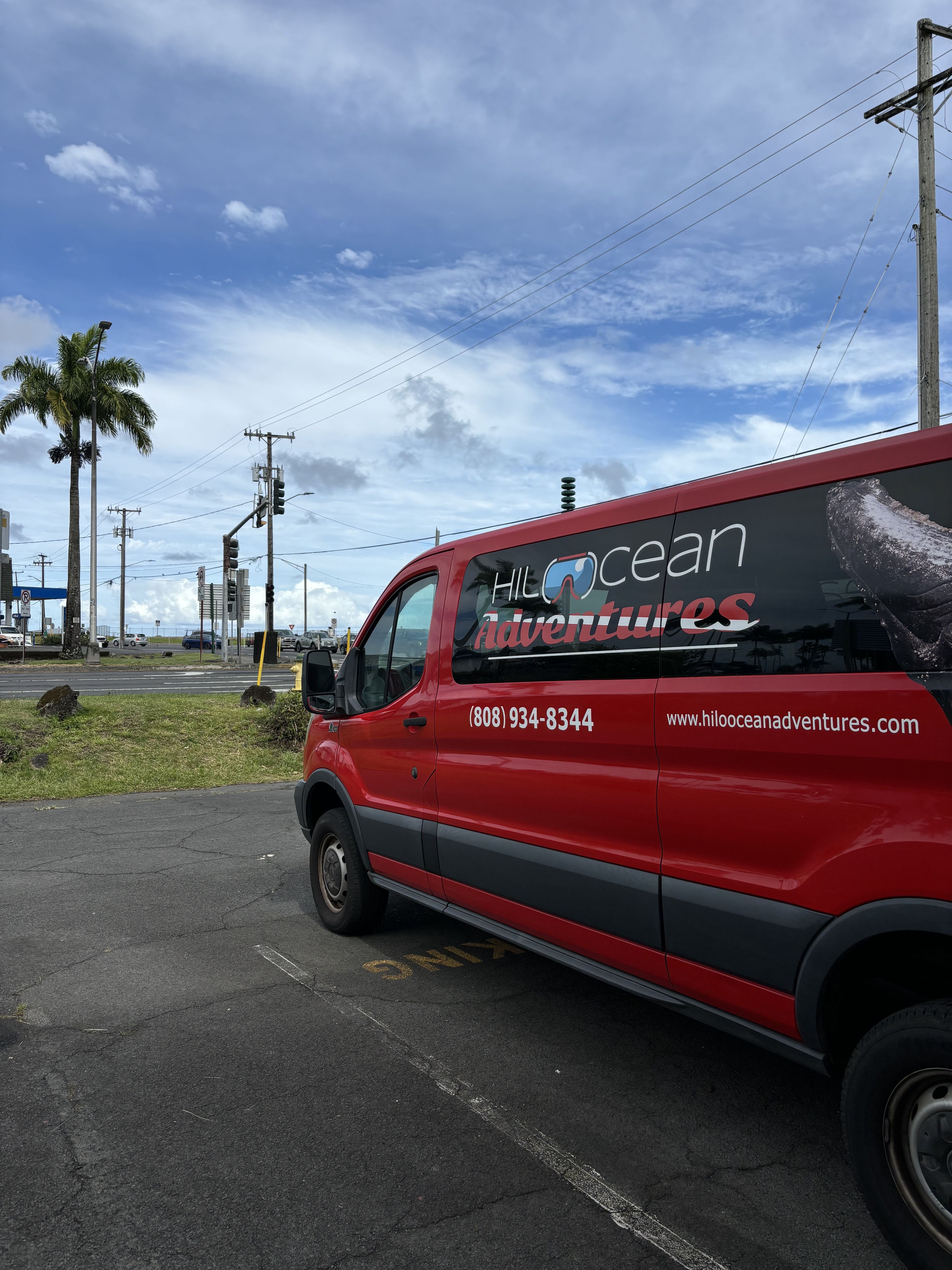 The Hilo Ocean Adventures van at the corner of Kamehameha Avenue and Banyan Drive in Hilo