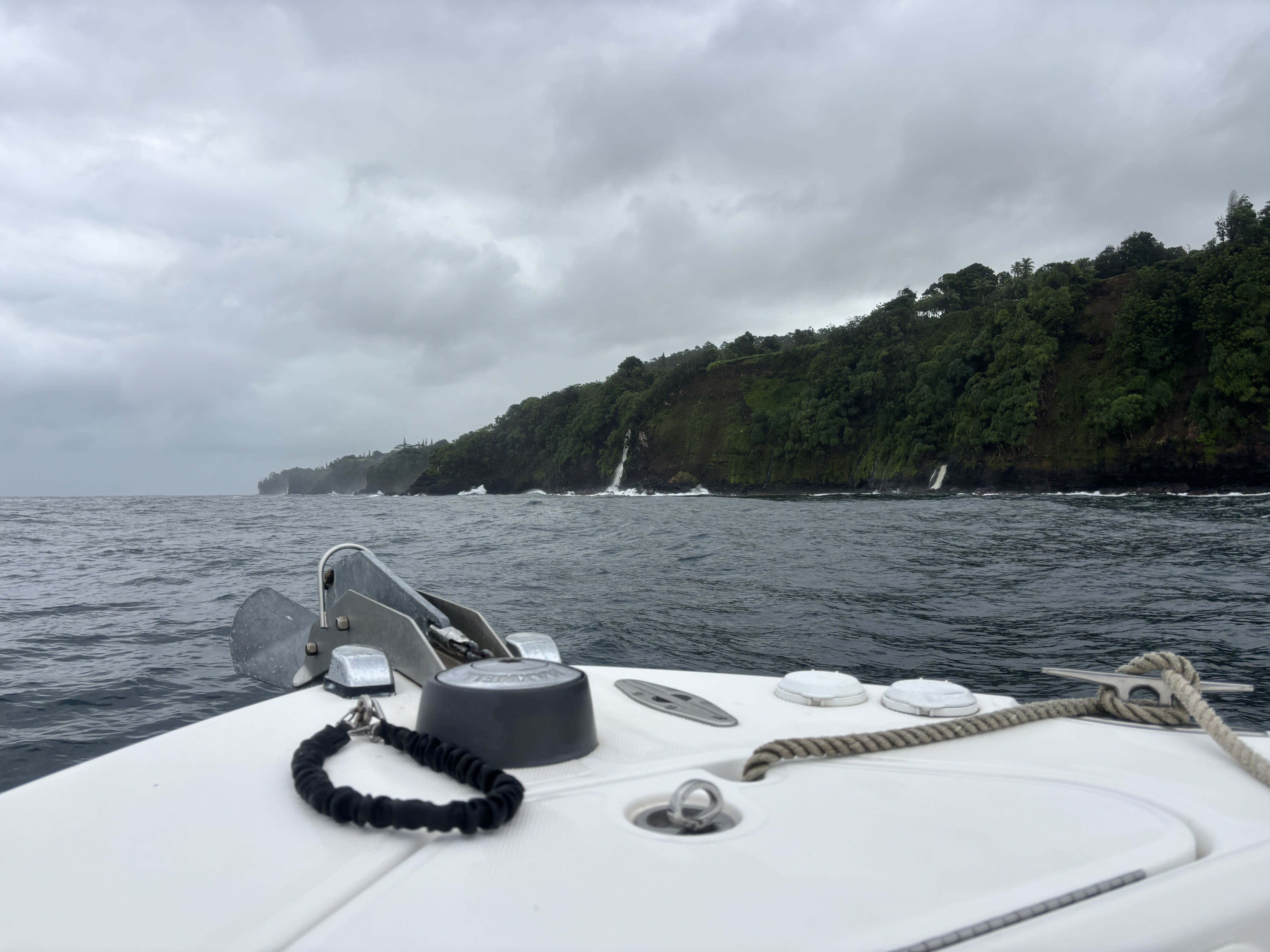 Hāmākua Coast cliffs and waterfalls seen from the boat on the way back to Hilo